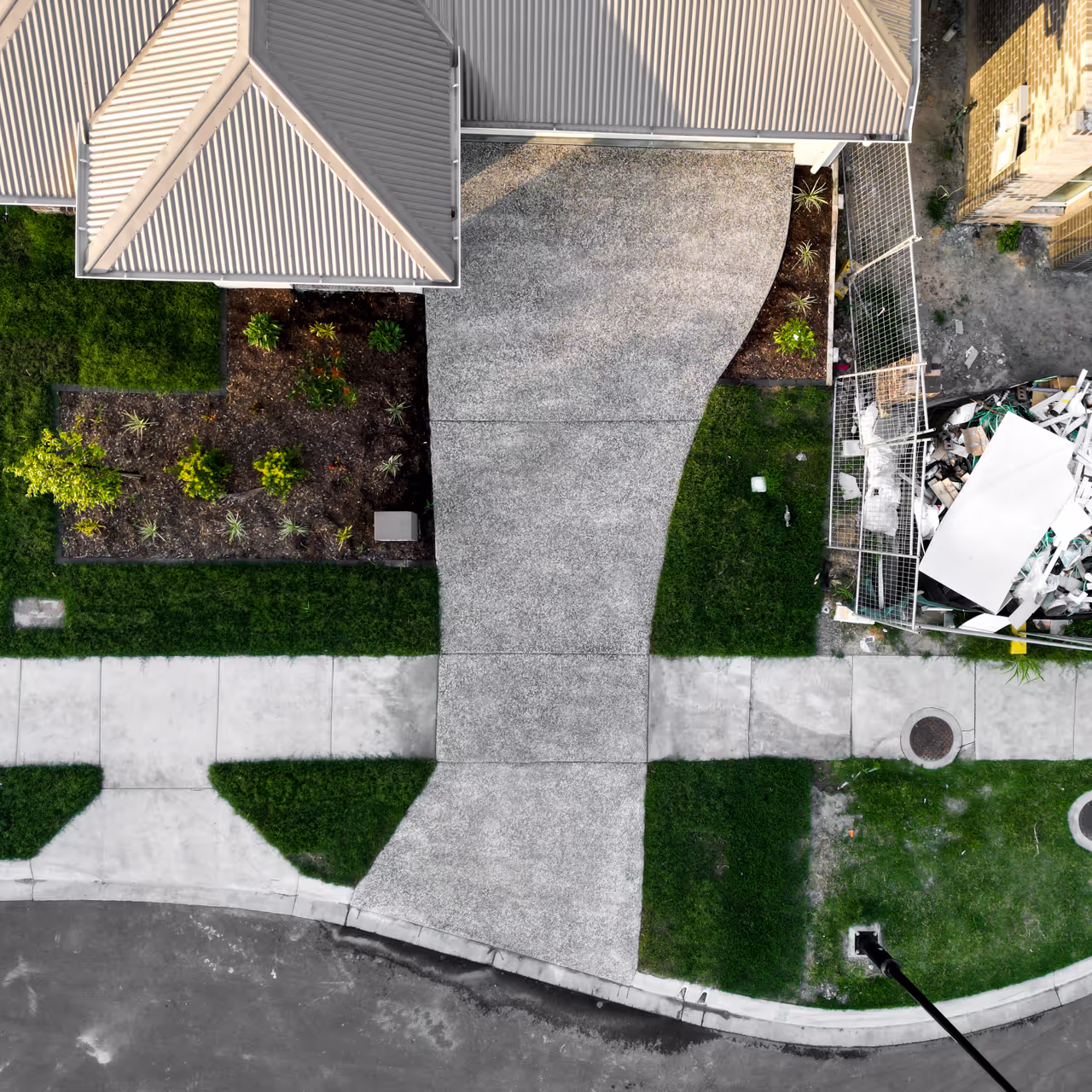 Drone view of sealed driveways and homes within an Inspire development