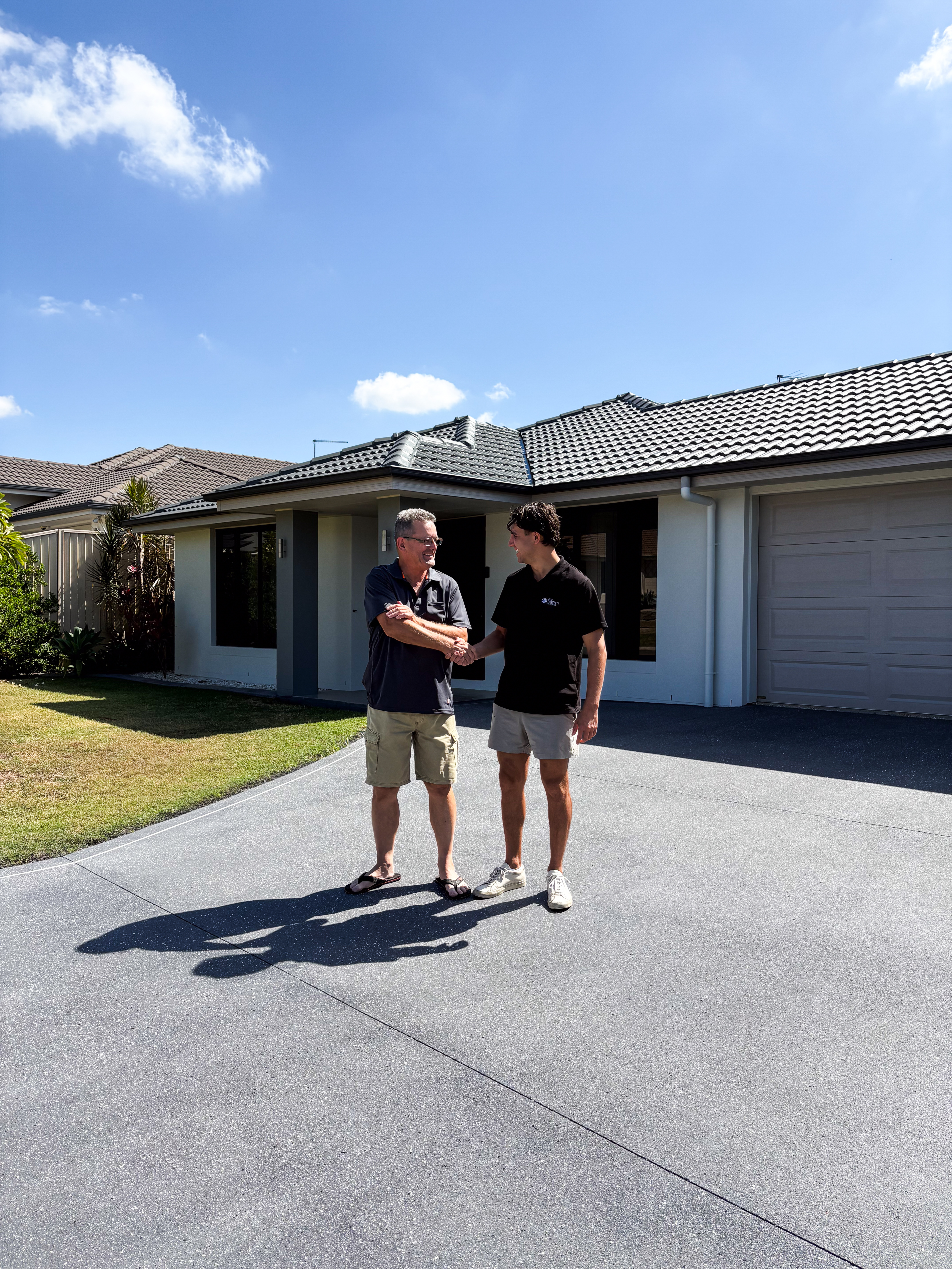 Lachlan from CoatPro handing a finished commercial floor over to a happy client