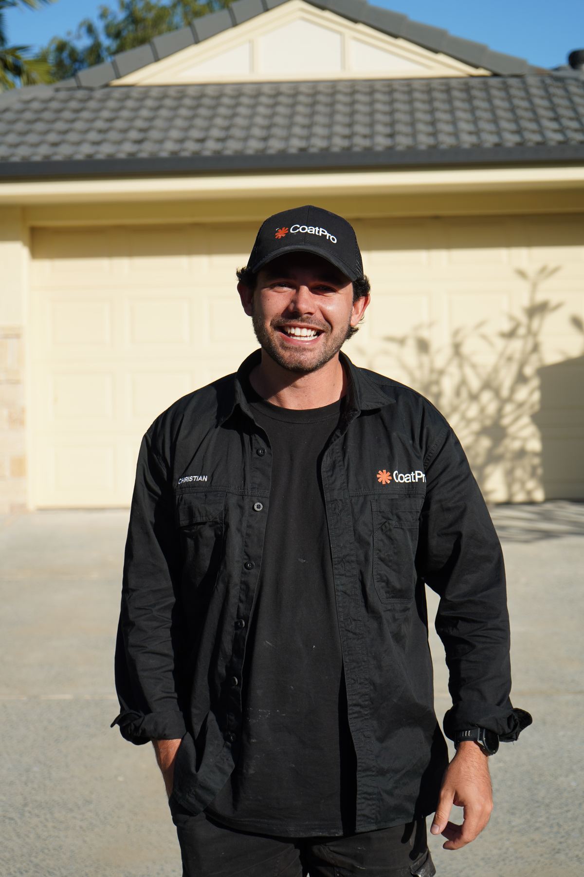 Christian smiling in CoatPro workwear in front of a finished job