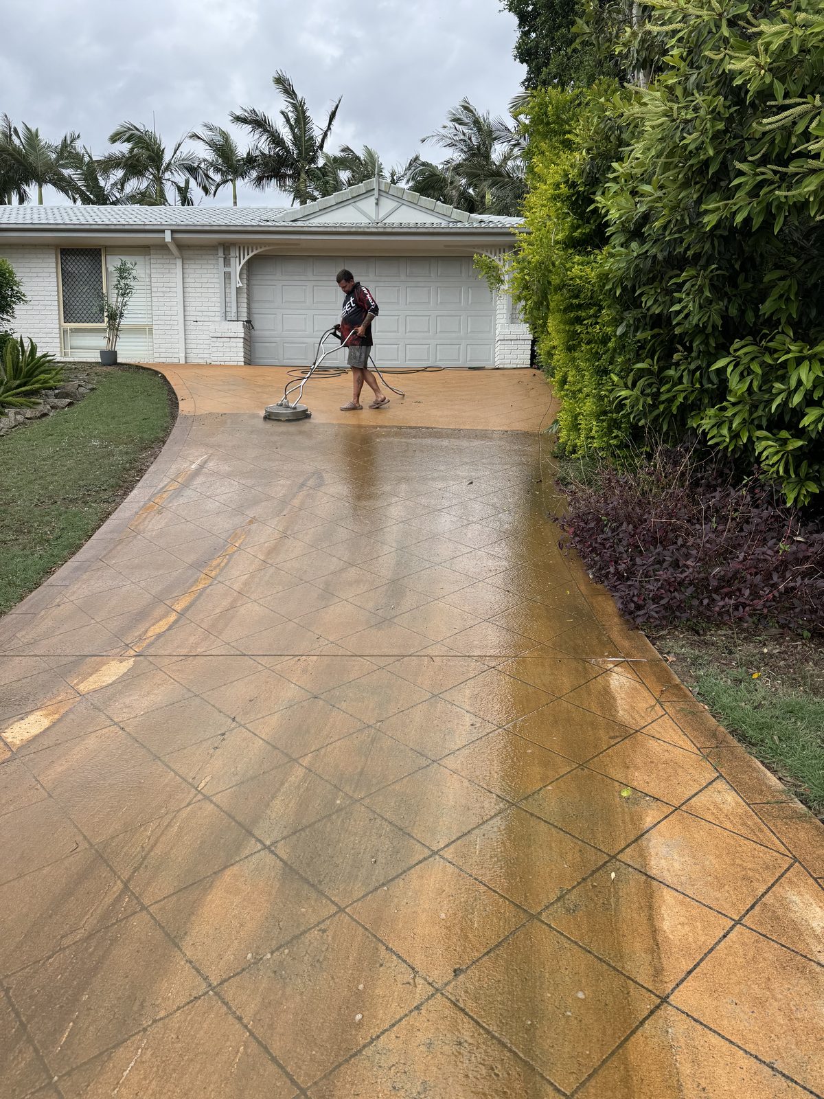 Faded stencilled driveway before coloured sealing