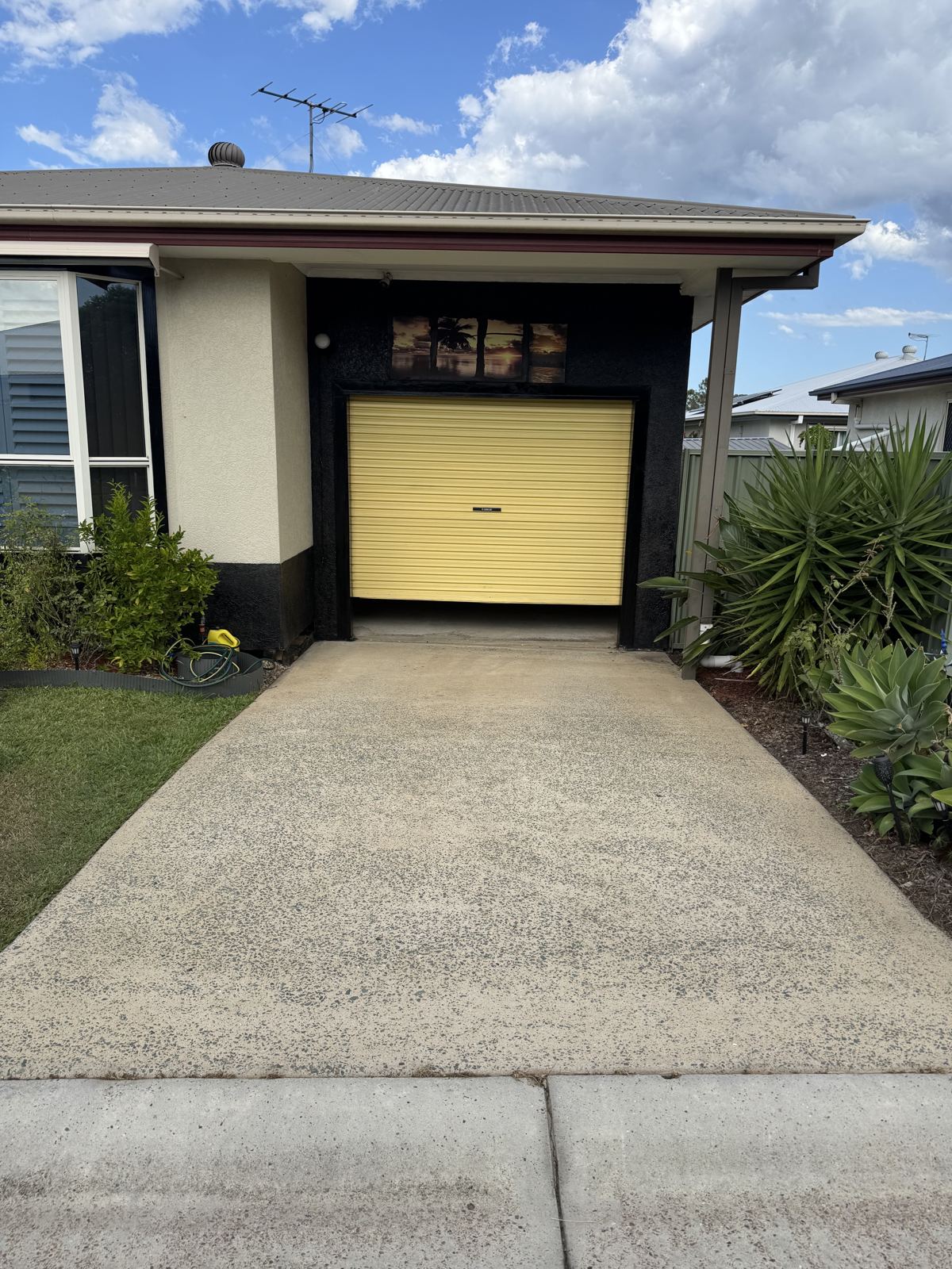 Before: Plain concrete driveway